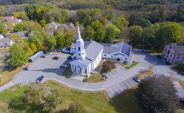 Unitarian Universalist Area Church aerial view on Washington Street in historic town center in fall